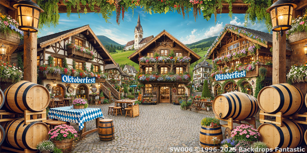 A festive village square decorated for Oktoberfest, featuring a Pirate B Party Backdrop among wooden barrels, flower boxes, outdoor tables, and alpine-style buildings under a blue sky.